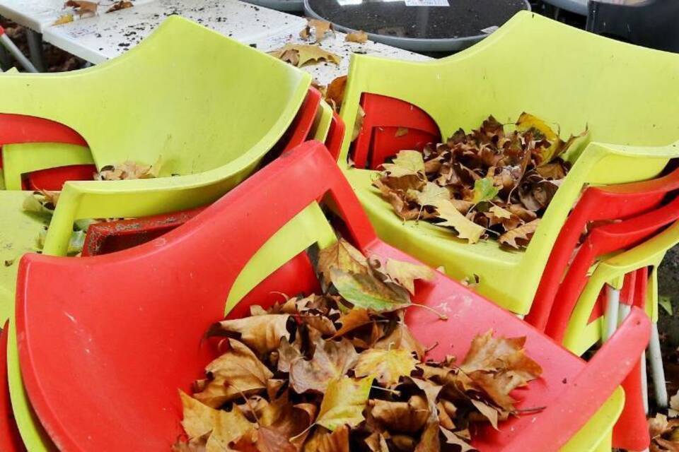 Herbstlaub liegt auf der Biergartenbestuhlung Herbstlaub liegt auf der Biergartenbestuhlung
