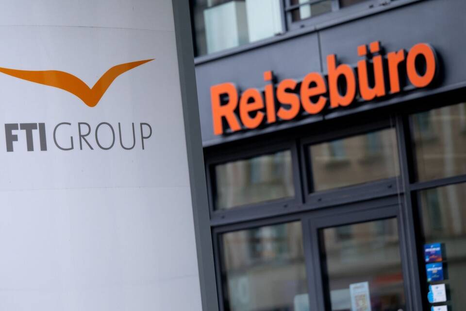 Das Logo des Reiseveranstalter FTI vor einem Reisebüro Das Logo des Reiseveranstalter FTI vor einem Reisebüro