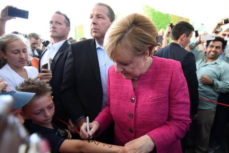 Merkel gibt Autogramme